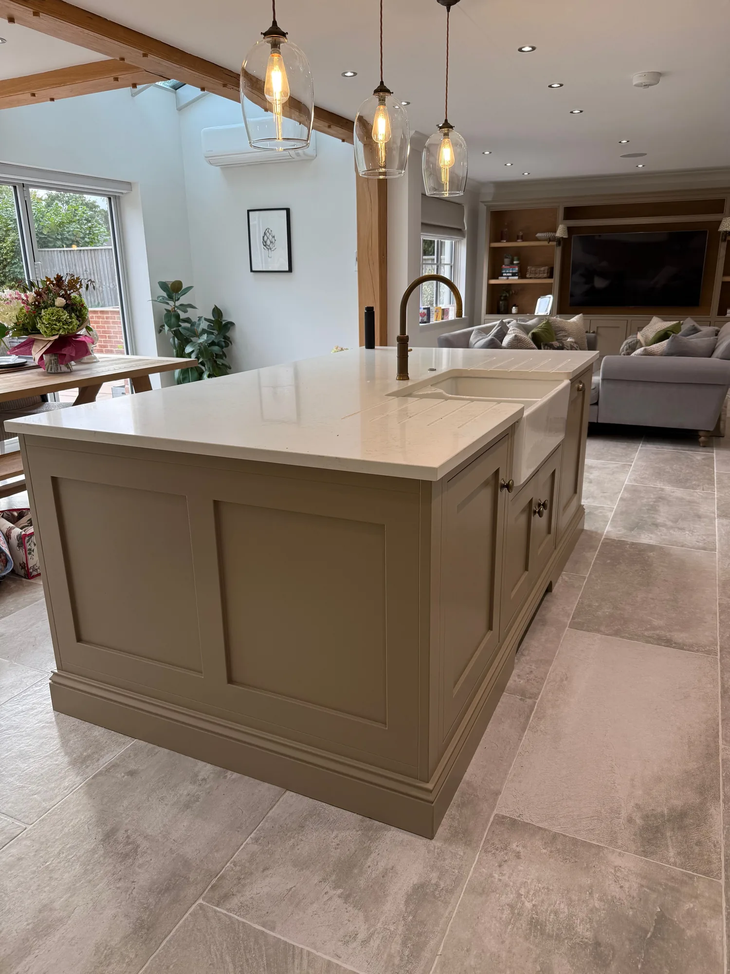 Sage green island kitchen with pendant lighting