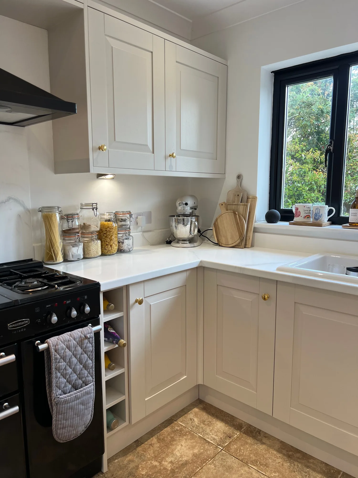 White worktop in a cream shaker kitchen with a range cooker