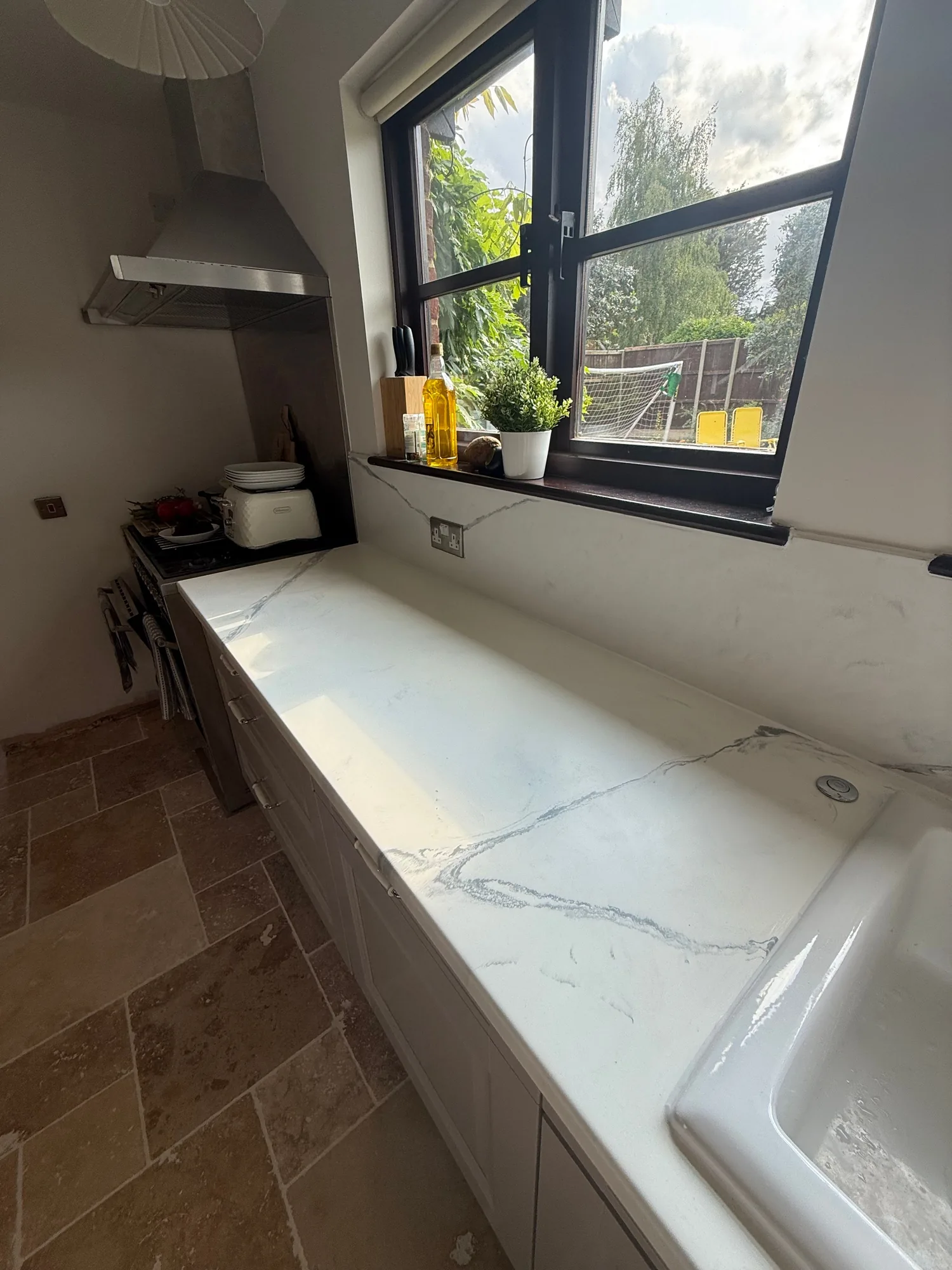 White marble effect worktop with a butler sink