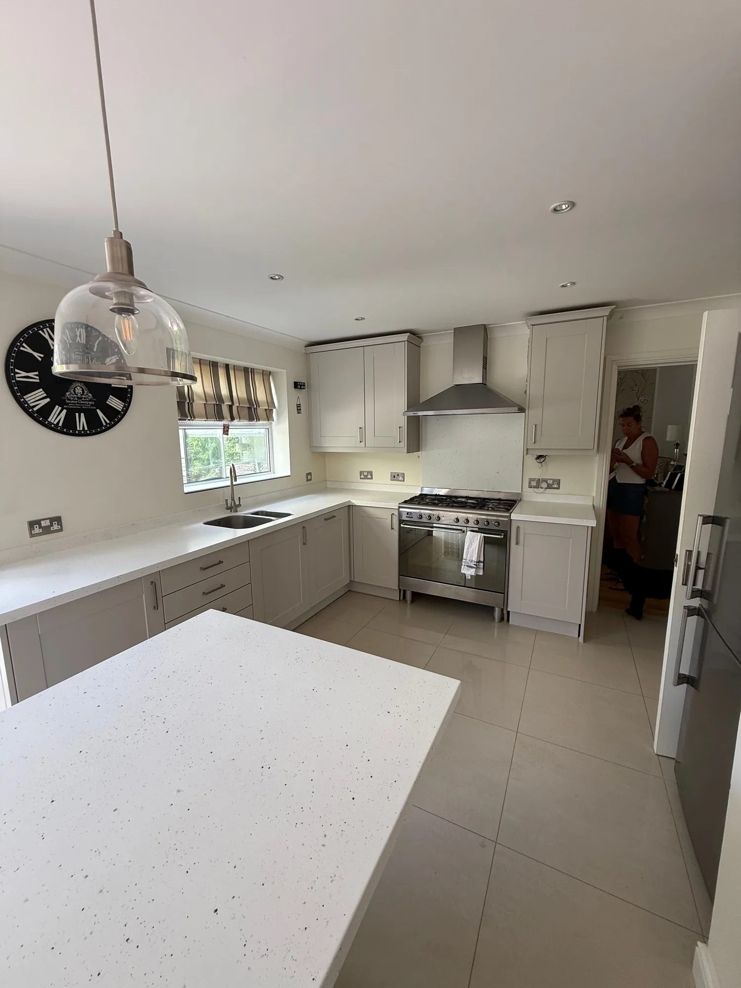 Kitchen island with a white worktop and pendant light
